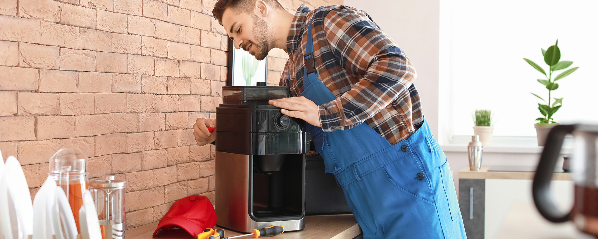 man repairing coffee machine in kitchen