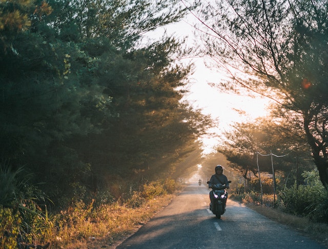 motorcycle driving at sunset